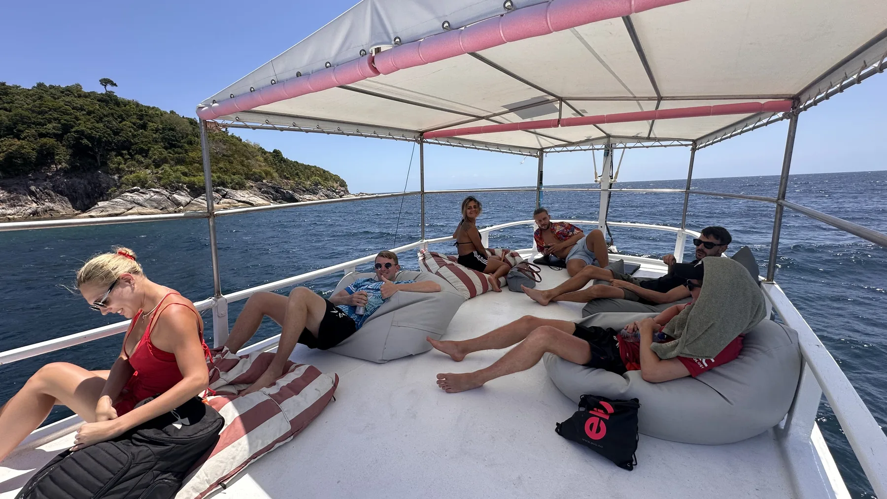 A group relaxing on bean bags between dives on the La Bombona dive boat, Koh Lipe