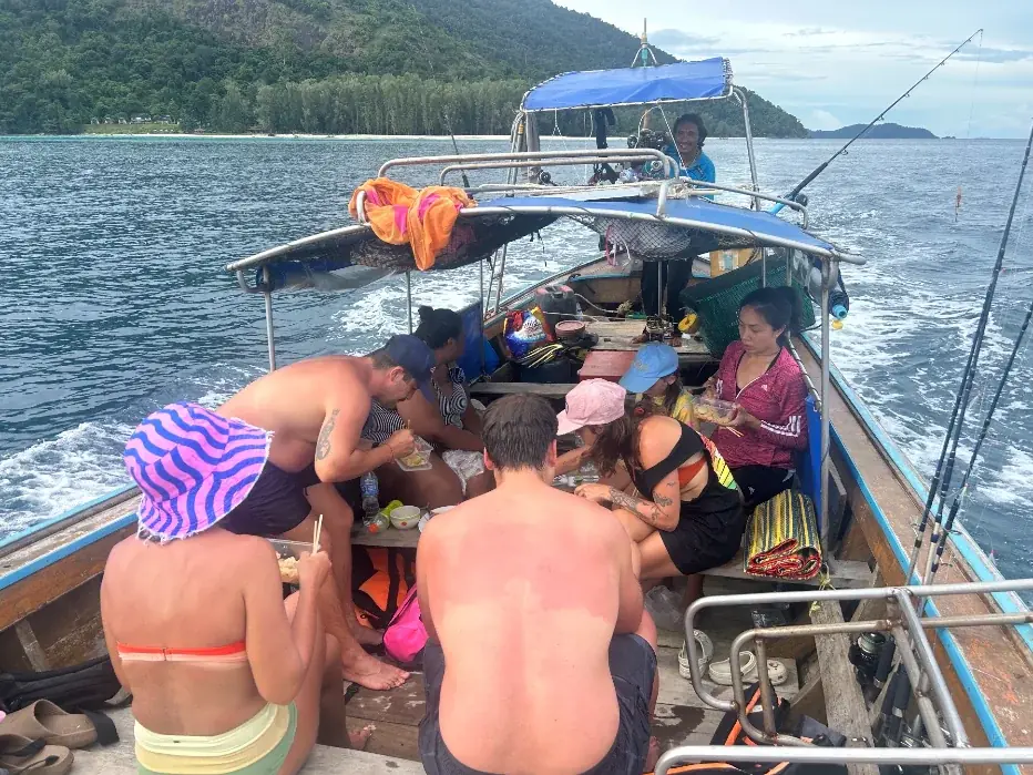Eating lunch on a longtail boat off Koh Adang during a Koh Lipe snorkel trip